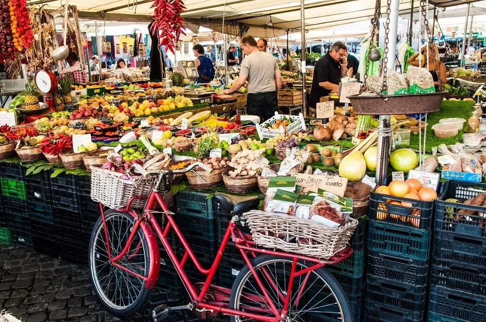 Campo de Fiori farmers market bustling with fresh produce vendors in Rome Italy