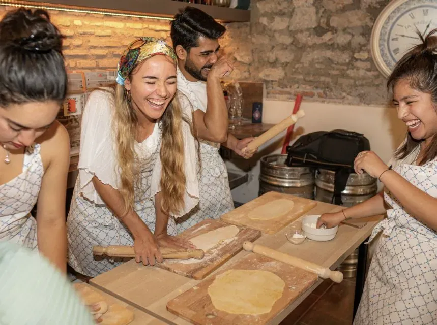 Group learning to make fresh pasta during a Carpe Diem Rome Spritz and Spaghetti cooking class