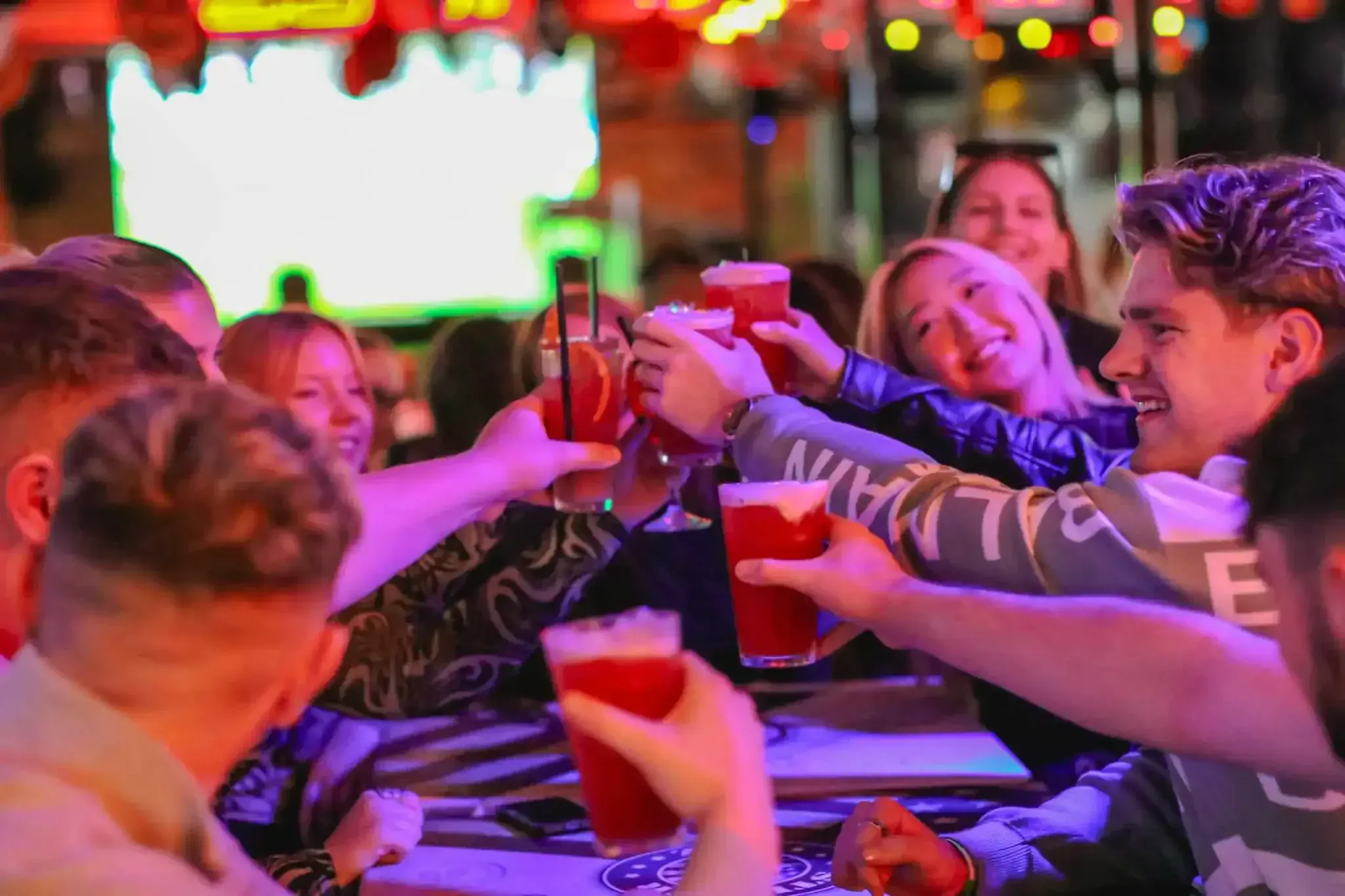 Group celebrating with drinks during Budapest nightlife tour