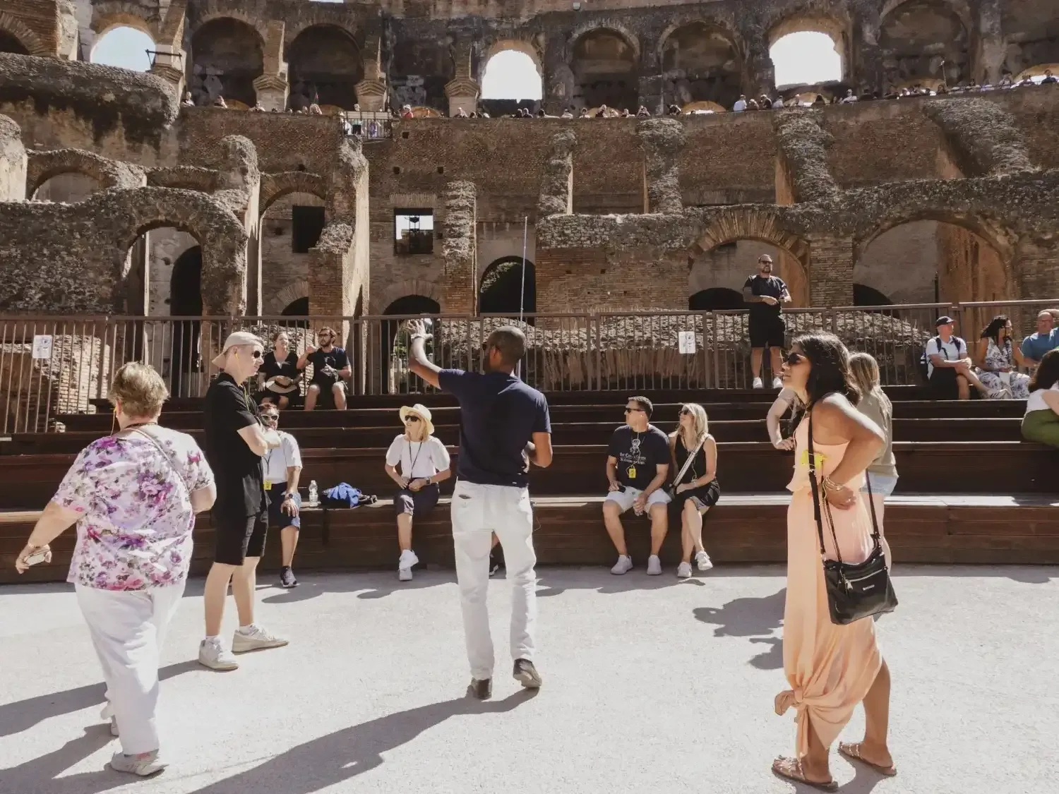 Tourists discovering the historical hypogeum chambers beneath the Colosseum arena