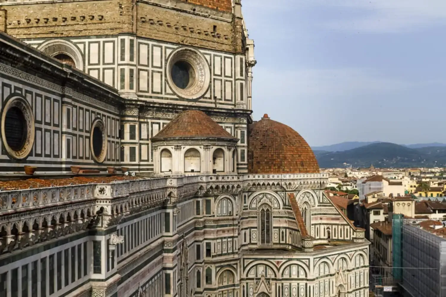 Florence Cathedral exterior with intricate white and green marble geometric patterns and Renaissance architectural details