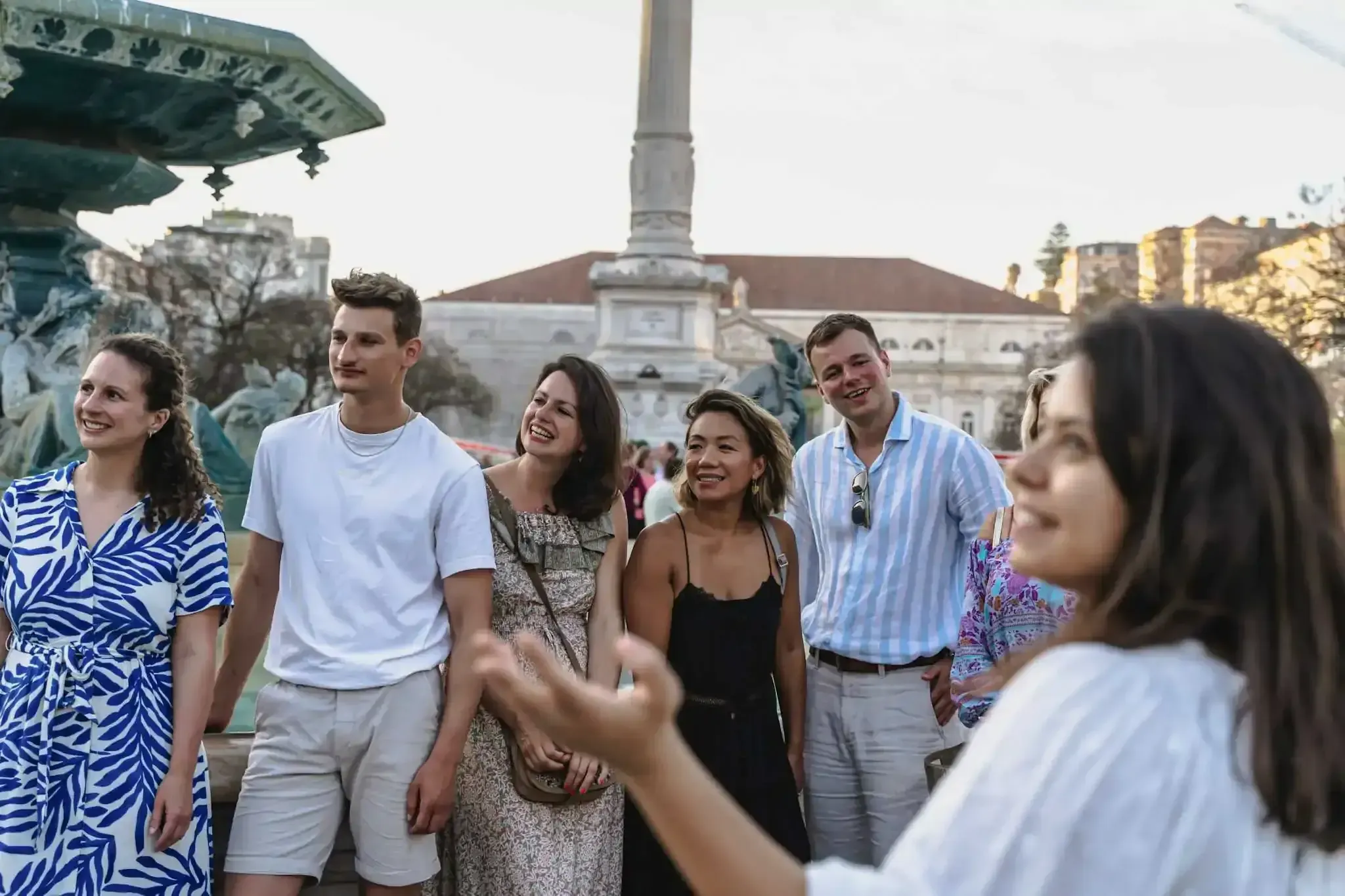 Travelers exploring Rossio Square during Lisbon walking tour