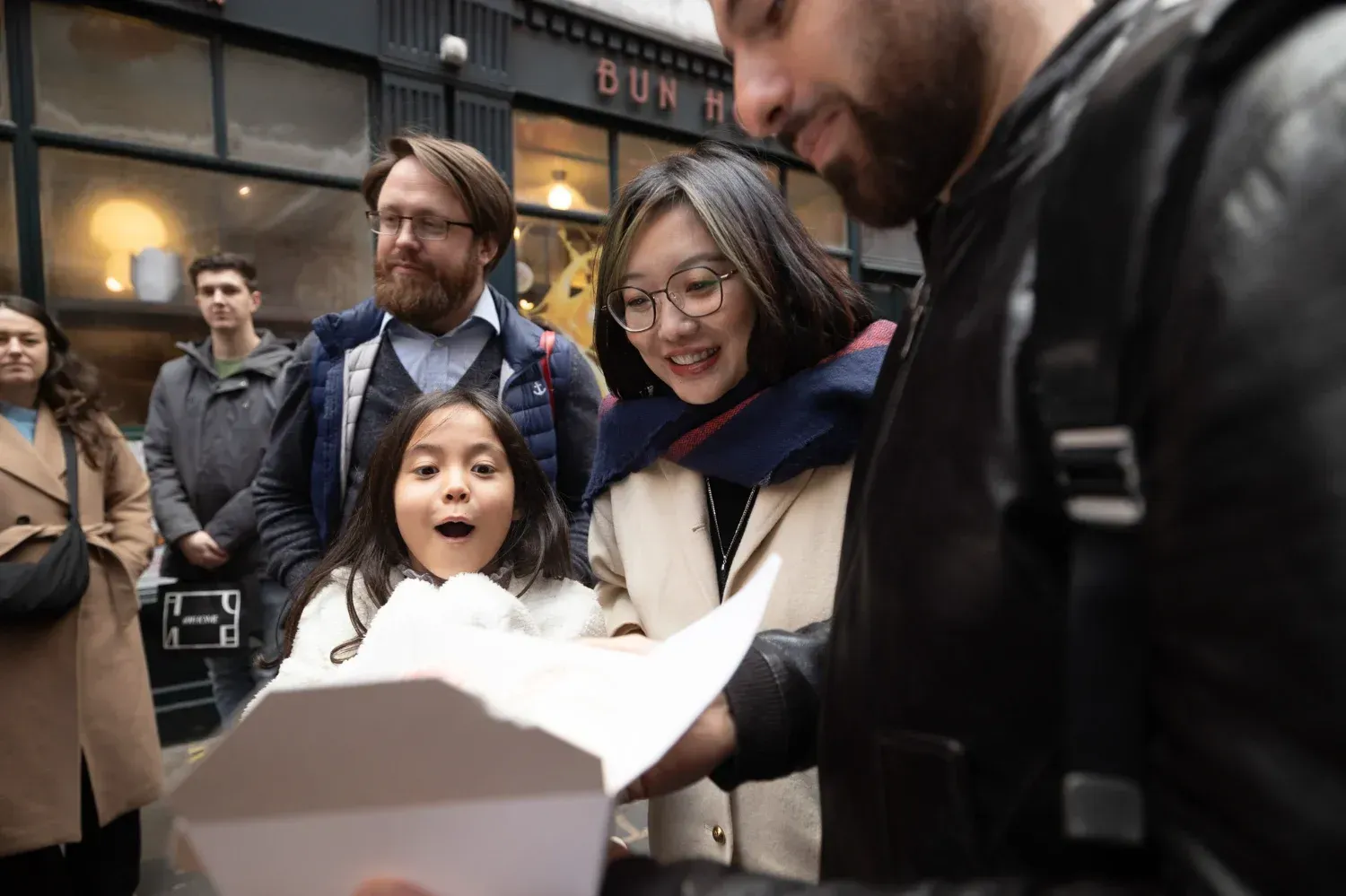 Travelers enjoying food and laughter at London Soho Food Tour dining table
