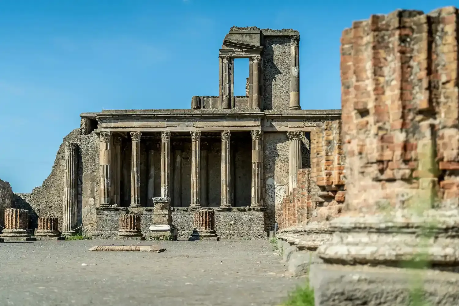 Mount Vesuvius volcano with dramatic crater landscape, volcanic slopes, and Naples cityscape in distant background