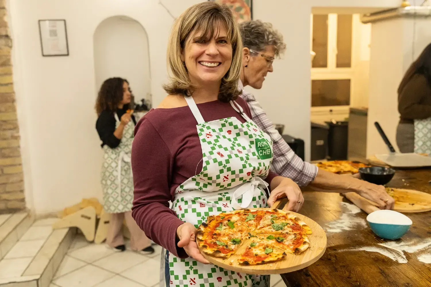 Woman enjoying homemade pizza during Pizza & Tiramisu Class cooking class