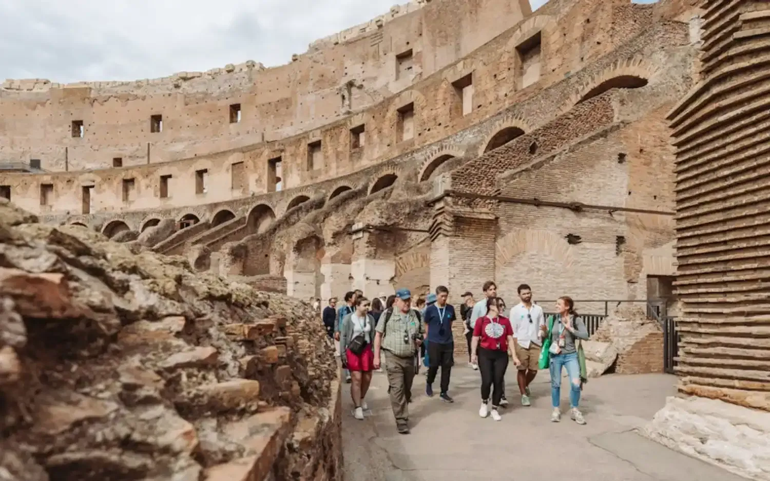 Guided tour group exploring the ancient Roman Colosseum with professional tour guide