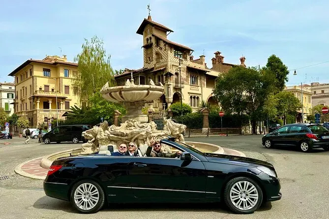 Couple enjoying a luxury black convertible Mercedes with open top in Piazza Navona Rome with historic fountain and architecture