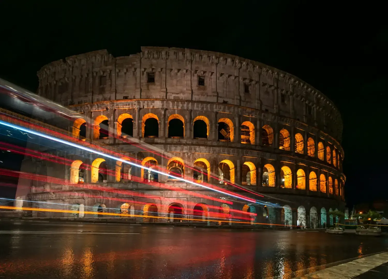 Rome cityscape at night with illuminated landmarks and city lights reflecting across the skyline