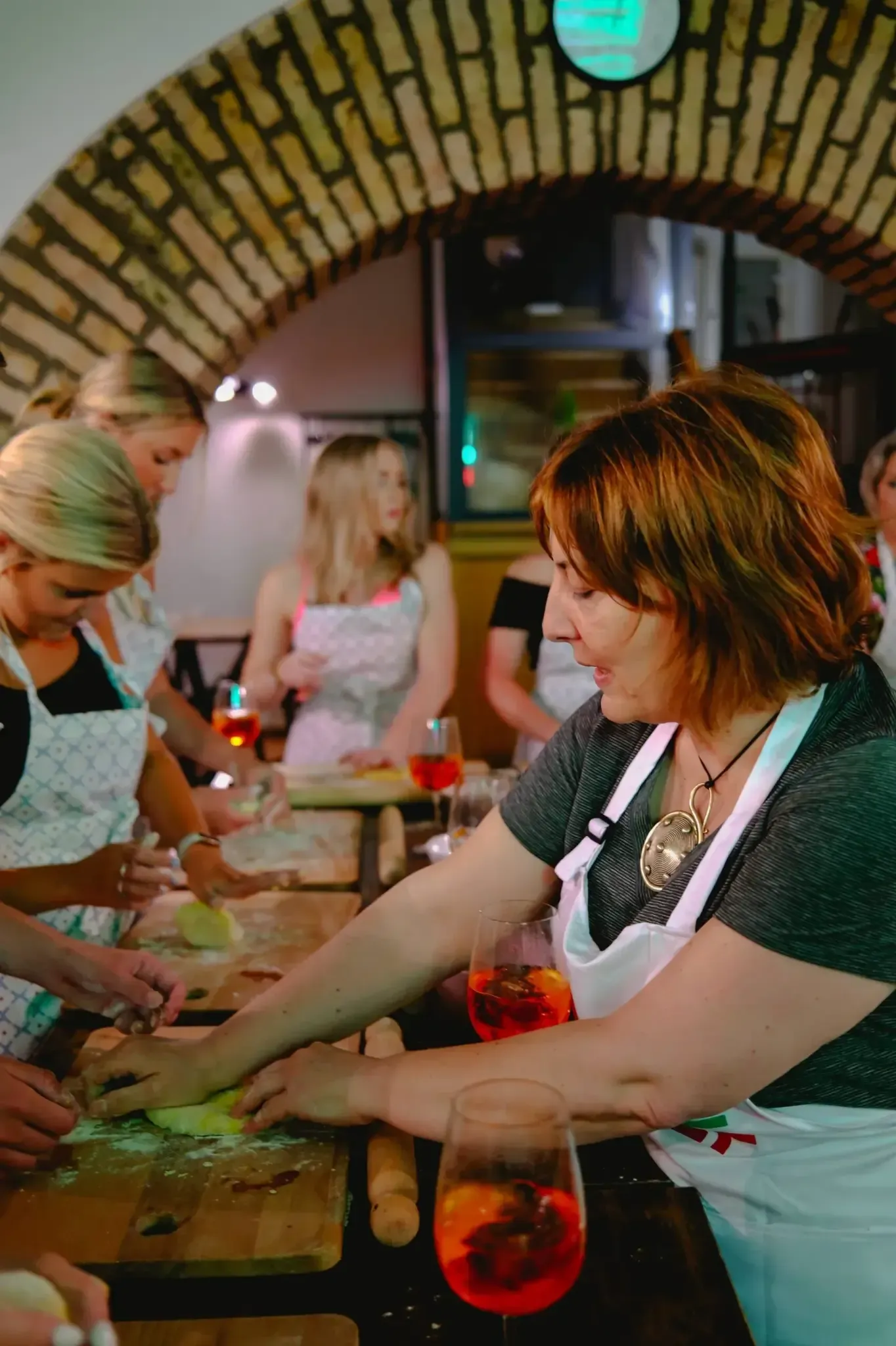 Chef presenting finished pasta dish during private Spritz & Spaghetti cooking class in Rome